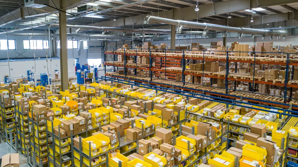 Industriële schoonmaak Gent in een groot logistiek magazijn met rekken
